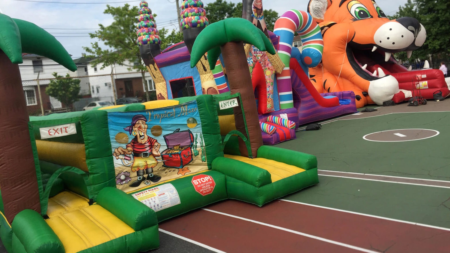 Inflatable amusement slide, obstacle course setup in schoolyard